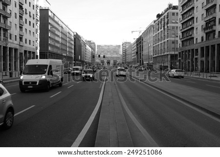 MILAN - JANUARY 28: View of Milan street wit traffic. In Background CENTRALE Train Station in black and White on January 28, 2015 in Milan, Italy.