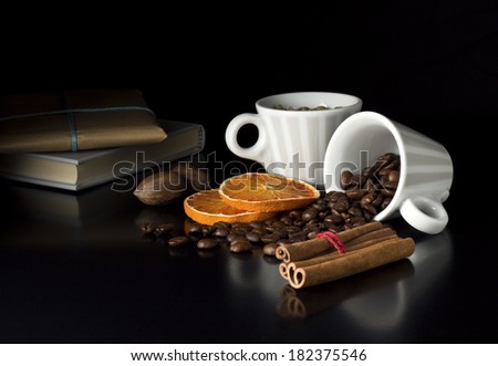 roasted coffee beans with fruits book and gift on black table