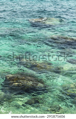 transparent water ripple, marine stones and sunlight glare. sea bottom backgrounds