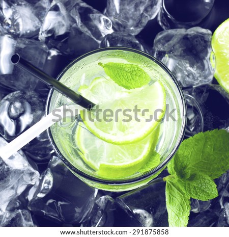cold Mojito cocktail with fresh lime, mint and ice. view from above