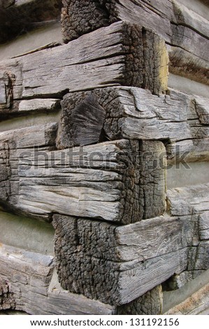 corner of pile of old logs or a cabin in the woods, rough wooden texture. Concept for hunting lodge, North American life, Canadian tourism, ecological sustainable material
