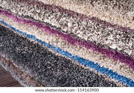 pile of carpets of different colors
