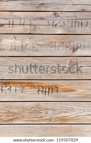 old wood texture with printed symbols