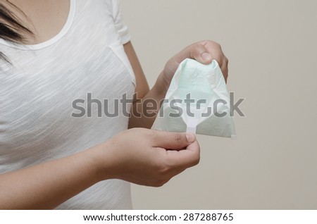woman's hand holding a daily sanitary pad.