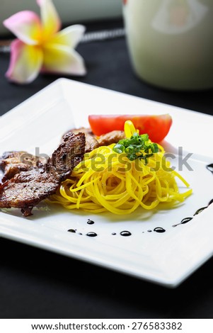 Yellow noodles with fried pork Food Thailand and China.