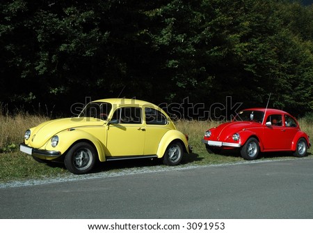 yellow volkswagen Beetle 1302 and red beetle 1300.