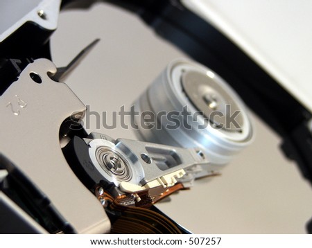 exposed computer hard disk focused on read/write mechanism