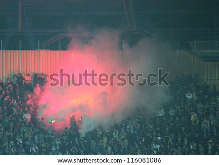 KHARKIV, UKRAINE - OCTOBER 7: FC Metalist Kharkiv fans burns fire during football match vs FC Shakhtar Donetsk, October 7, 2012 in Kharkov, Ukraine