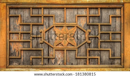 The ancient wooden wall frame is decorated with carving wood designed in Chinese pattern