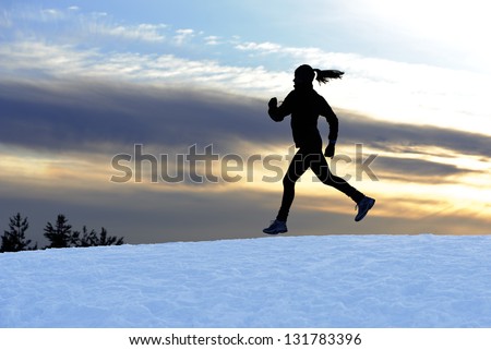 Female athlete running outdoors in winter
