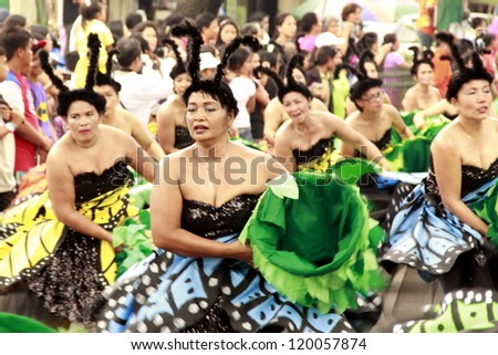 CAVITE, PHILIPPINES - NOV. 26: Government employees participate in the 2nd Paru-paro Festival on November 26, 2012 in Dasmarinas, Cavite.  Every group compete with street dance & costume competition.