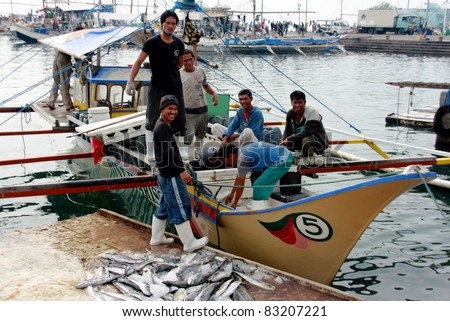 GEN. SANTOS CITY, PHILIPPINES - AUG 20: Workers unload fresh tunas at Gen. Santos Fish Port in Gen. Santos City, Philippines on Aug. 20, 2011. Catching tunas is one of main source of income for locals