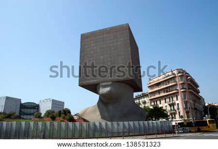 NICE, FRANCE - MAY 2: Square Head - building cube shaped as human head sculpture on May 2, 2013 in Nice, France. Authors are sculptor Sacha Sosno and architect Yves Bayard. Opened on June 29, 2002.