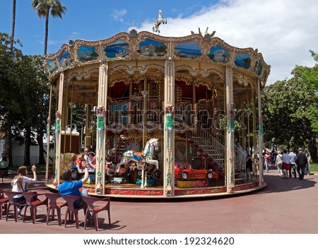 CANNES, FRANCE - MAY 6: Vintage merry-go-round with horses and other animals for kids at Croisette promenade on May 6, 2013 in Cannes, France.