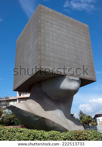 NICE, FRANCE - JUNE 4, 2014: Square Head - building cube shaped as human head sculpture. Authors are sculptor Sacha Sosno and architect Yves Bayard. Opened on June 29, 2002.