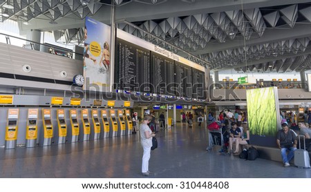 FRANKFURT AM MAIN, GERMANY - JULY 2, 2015: Travelers at public area at international Frankfurt Airport, the busiest airport in Germany. Longer exposure.