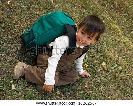 Little funny boy with backpack just come back from school