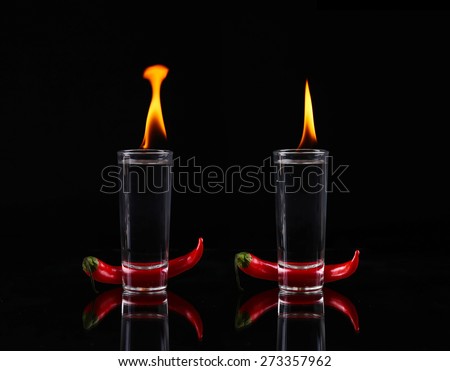 collage Hot chili pepper in a shot glass with a fire on a black background