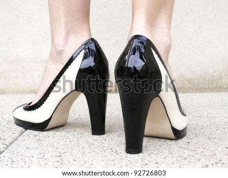 A Woman Wearing A Pair Of Black & White Classic High Heels With ...