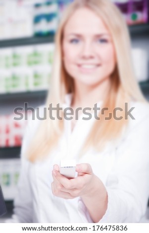 Sales clerk at pharmacy hands over pharmaceuticals