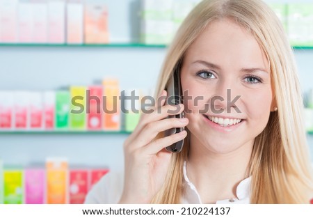 Pharmacy assistant making a phone call