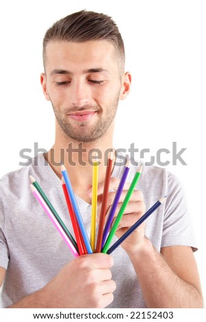 A handsome man chooses a colored crayon.  All isolated on white background. Stock foto © 