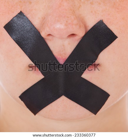 Taped mouth of a female person.
