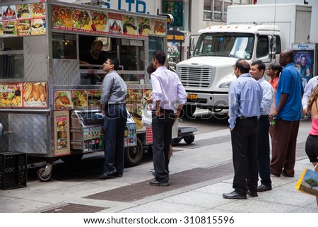 NEW YORK CITY, USA - SEPTEMBER, 2014: Businessmen during lunch at food cart