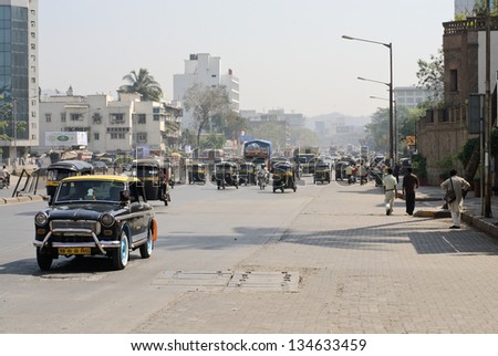 MUMBAI, INDIA - JANUARY 27:  Traditional indian black and yellow taxi drive along Mathuradas Vasanji Road on January 27, 2008 in Mumbai