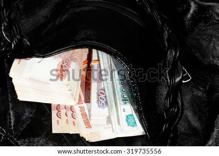 Large sum of russian rubles in open woman handbag