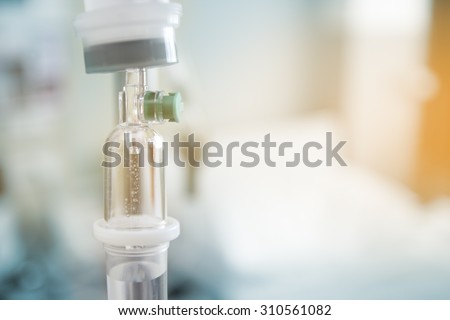 Close up saline IV drip for patient and Infusion pump in hospital.