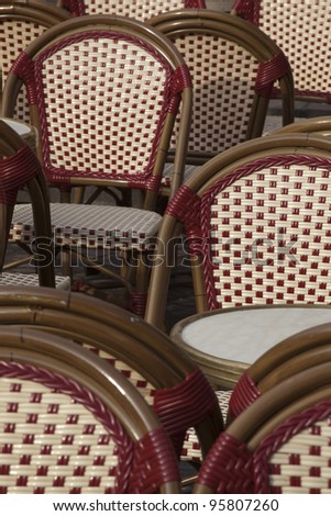 Rows of tables and chairs lie empty awaiting the first customers of the day. These ones are found in old Tours, France.