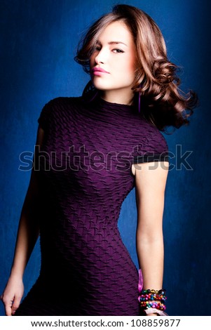 elegant young lady in violet dress, studio shot
