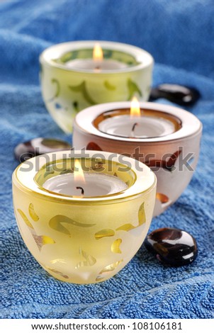 three candles in row on background blue