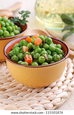 Peas soup and carrots in small bowl
