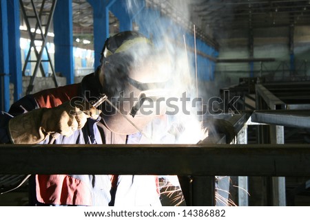 The electric welder on the workplace at a factory at installation of a design