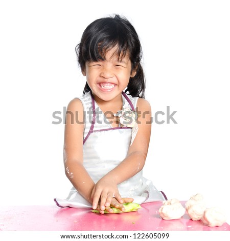 Little girl makes play dough on white background.