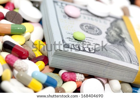 Money bundle (pack) among various drugs (pills, tablets, capsules)