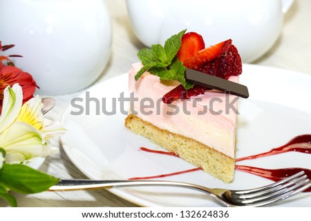 dessert, a piece of cake on the table with a cup of tea