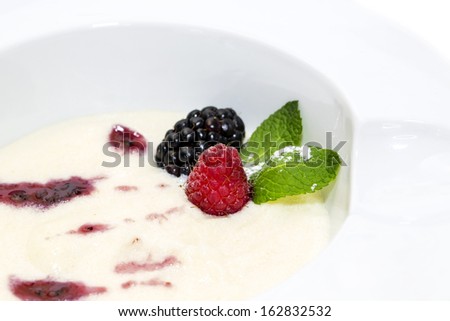 semolina porridge with berries decorated with berry jam