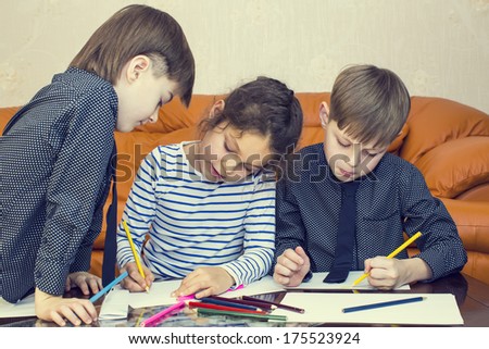 children draw with crayons on paper