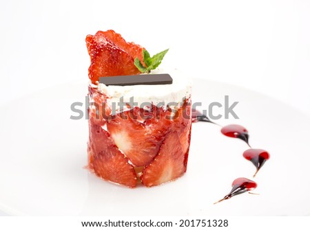 strawberry cream dessert decorated with strawberries and chocolate
