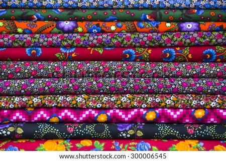 Background of the scrolls rolls colored colorful fabric