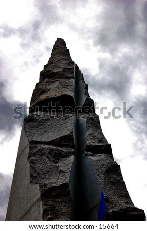 Parts of a tower-like monument. The idea of the picture is a god-like monument, with a touch to the sky. The lowkey lighting goes in hands with the cloudy sky, while the touch of blue brings a \'non-B&W\' effect.