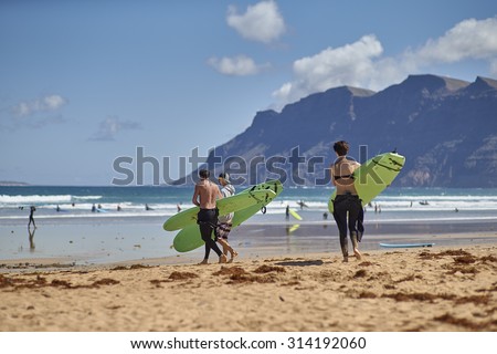 FAMARA BEACH, LANZAROTE ISLAND - APRIL 15. 2015: Surf lesson. Learners are about to enter the water at Famara beach. Spain.