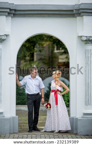 groom carrying bride near church