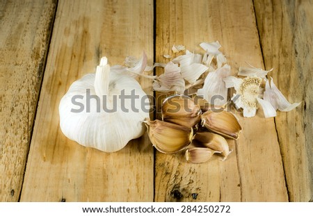 Garlic with peel on the wooden surface