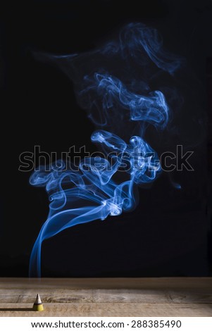 Blue smoke moving upper to from cone shape incense stick