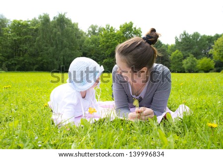 Mom and baby resting in the green grass