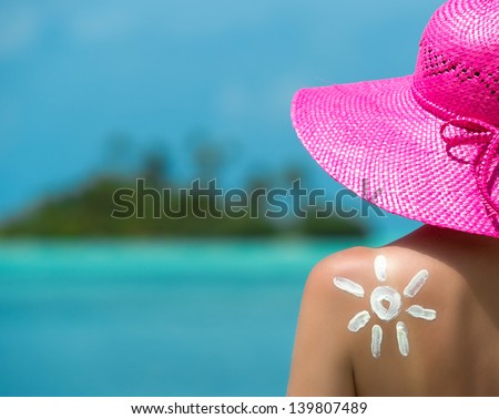 Woman with sun-shaped sun cream
